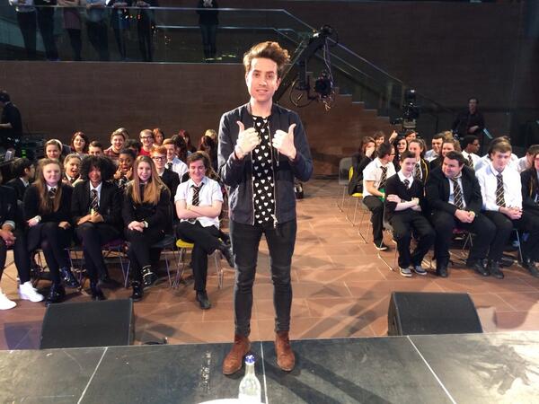 Some grinning qmunicaters and Nick Grimshaw